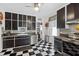 Retro kitchen with stainless steel appliances and black and white checkered floors at 350 E Park Ave, Lake Wales, FL 33853