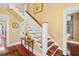 Elegant staircase with white railings and a decorative runner at 350 E Park Ave, Lake Wales, FL 33853