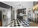 Retro kitchen with stainless steel appliances and black and white checkered floors at 350 E Park Ave, Lake Wales, FL 33853