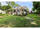 Two story home with wraparound porch, lush landscaping, and large yard at 350 E Park Ave, Lake Wales, FL 33853