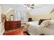 Charming bedroom with wooden dresser and a floral patterned bedspread at 350 E Park Ave, Lake Wales, FL 33853