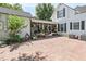 Brick paved patio with screened porch and abundant potted plants at 350 E Park Ave, Lake Wales, FL 33853
