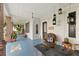 Spacious front porch with blue painted floors, wicker chairs, and hanging lights at 350 E Park Ave, Lake Wales, FL 33853