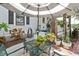 Relaxing patio area with metal table and chairs, lush plants at 350 E Park Ave, Lake Wales, FL 33853