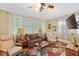 Cozy living room features a brown sofa, two armchairs, and a coffee table at 350 E Park Ave, Lake Wales, FL 33853