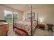 Spacious bedroom with a large four-poster bed and ample natural light at 3017 Mission Lakes Dr, Lakeland, FL 33803