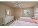 Charming bedroom with twin beds, white dresser, and window with blinds at 3017 Mission Lakes Dr, Lakeland, FL 33803