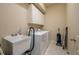 Convenient laundry room with washer, dryer, utility sink, and cabinets at 3017 Mission Lakes Dr, Lakeland, FL 33803