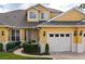 Yellow two-story home with two-car garage and landscaping at 3017 Mission Lakes Dr, Lakeland, FL 33803