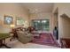 Spacious living room with vaulted ceiling, fireplace, and access to a patio at 3017 Mission Lakes Dr, Lakeland, FL 33803