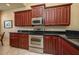 Kitchen with stainless steel appliances and dark wood cabinets at 3017 Mission Lakes Dr, Lakeland, FL 33803