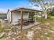 Backyard with covered patio and work bench at 404 Thomas Ave, Frostproof, FL 33843