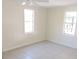 Simple bedroom with tile floor and two windows at 5016 Washington St, Lake Wales, FL 33859