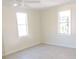 Bright bedroom with tile floors and two windows at 5016 Washington St, Lake Wales, FL 33859
