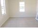 Simple bedroom with tile floors and window at 5016 Washington St, Lake Wales, FL 33859