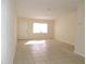 Bright living room with tile floors and an exterior door at 5016 Washington St, Lake Wales, FL 33859
