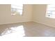Bedroom with tile floors and two windows at 5016 Washington St, Lake Wales, FL 33859