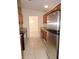Kitchen with wood cabinets, stainless steel appliances, and tile floors at 5016 Washington St, Lake Wales, FL 33859