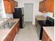 Kitchen with wood cabinets, stainless steel appliances, and tile floors at 5016 Washington St, Lake Wales, FL 33859