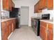 Kitchen with wood cabinets, stainless steel appliances, and tile floors at 5016 Washington St, Lake Wales, FL 33859