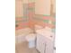 Bathroom with pink and green tile and white vanity at 5016 Washington St, Lake Wales, FL 33859