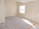 Simple bedroom with grey carpet and large window at 5016 Washington St, Lake Wales, FL 33859