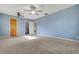 Large bedroom with blue walls, carpet, and ceiling fan at 40 Britton St, Babson Park, FL 33827