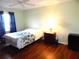 Comfortable bedroom with a queen-size bed and wood-look floors at 914 Oxford Way, Lake Wales, FL 33853