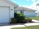 House exterior with garage and well-manicured landscaping at 914 Oxford Way, Lake Wales, FL 33853