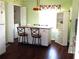 Bright kitchen with white cabinets, an island, and wood-look floors at 914 Oxford Way, Lake Wales, FL 33853