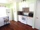 White kitchen features mosaic backsplash and modern appliances at 914 Oxford Way, Lake Wales, FL 33853