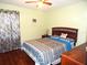 Charming bedroom with a ceiling fan and decorative bedding at 914 Oxford Way, Lake Wales, FL 33853