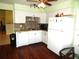 White kitchen with granite countertops and tile backsplash at 914 Oxford Way, Lake Wales, FL 33853