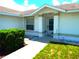 House entrance with walkway, shrubs, and a light at 914 Oxford Way, Lake Wales, FL 33853