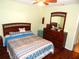 Bedroom with full-size bed and wood-look floors at 914 Oxford Way, Lake Wales, FL 33853