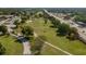 Aerial view showing the community's location near a golf course and road at 8203 Village Dr # 8203, Lake Wales, FL 33898
