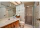 Bathroom with wood vanity, single sink, and walk-in shower at 8203 Village Dr # 8203, Lake Wales, FL 33898