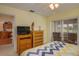 Bedroom with king-size bed, dresser, and view of kitchen at 8203 Village Dr # 8203, Lake Wales, FL 33898