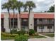 Two-story building with Spanish-style architecture and lush landscaping at 8203 Village Dr # 8203, Lake Wales, FL 33898
