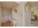 Bright entryway with glass-top table, wood floors, and access to bedroom at 8203 Village Dr # 8203, Lake Wales, FL 33898