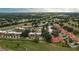 Aerial view of a condo community near a lake and golf course at 8203 Village Dr # 8203, Lake Wales, FL 33898