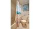Clean bathroom with a tub, toilet, and beach-themed shower curtain at 8203 Village Dr # 8203, Lake Wales, FL 33898