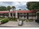 Exterior view of a two-story building with Spanish tile roofs and parking at 8203 Village Dr # 8203, Lake Wales, FL 33898