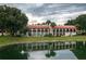 Building exterior on a canal with palm trees and lush landscaping at 8203 Village Dr # 8203, Lake Wales, FL 33898