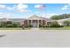 Community clubhouse with inviting entryway and flagpole at 231 Lake Suzanne Dr, Lake Wales, FL 33859