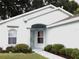 Well-maintained house with light-blue exterior, landscaping, and a walkway at 231 Lake Suzanne Dr, Lake Wales, FL 33859