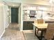 Inviting entryway with dark-painted door and view into dining and kitchen areas at 220 La Casa # 220, Lake Wales, FL 33898