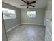 Well-lit bedroom featuring tile floors and a ceiling fan at 1815 Moose Dr, Lakeland, FL 33801