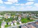 Aerial view of community, featuring homes, lake, and lush green landscape at 341 Lake Suzanne Dr, Lake Wales, FL 33859