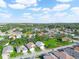 Aerial view showcasing a neighborhood with houses near a lake at 341 Lake Suzanne Dr, Lake Wales, FL 33859